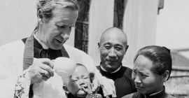 Bishop Edward Galvin baptizing a baby